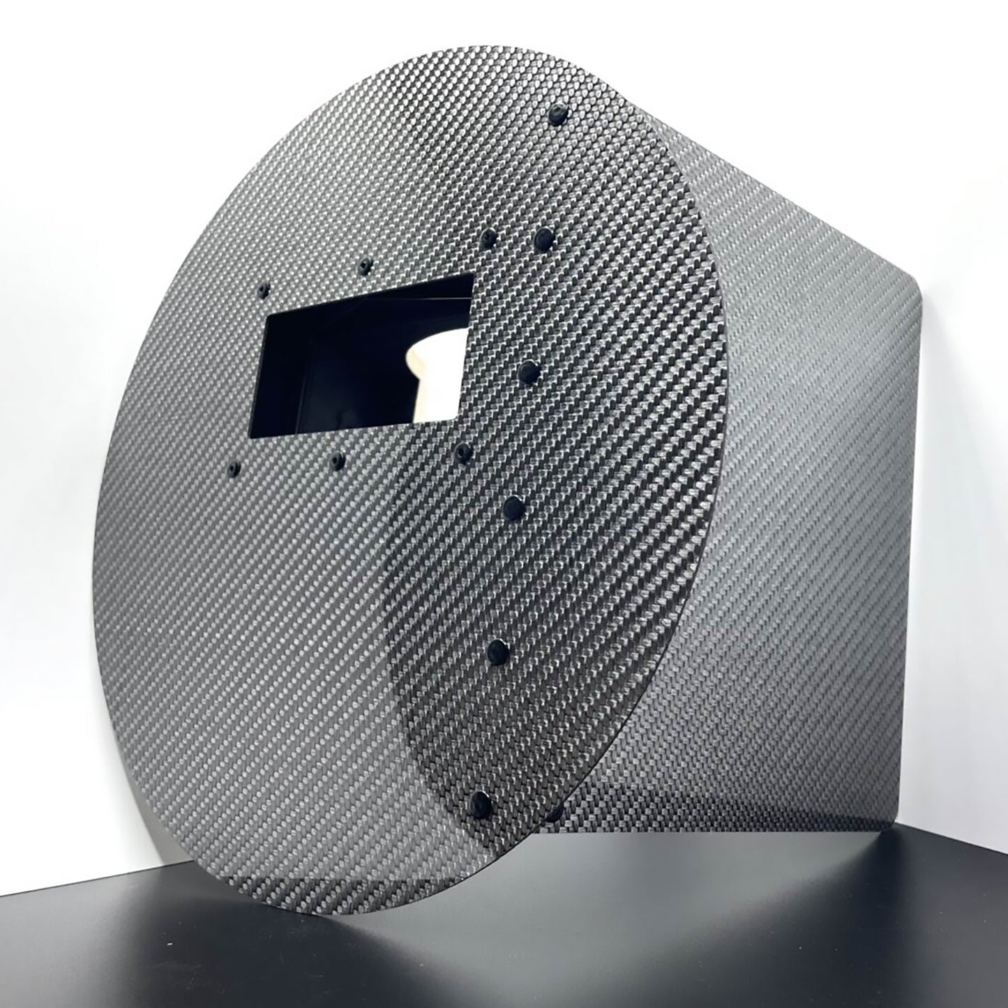 Carbon fiber panel with a textured surface on a white background