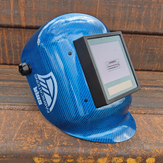 CMR Fabrications Carbon fiber Pipeliners Sugar scoop welding helmet Blue with digital display on a rusty metal surface
