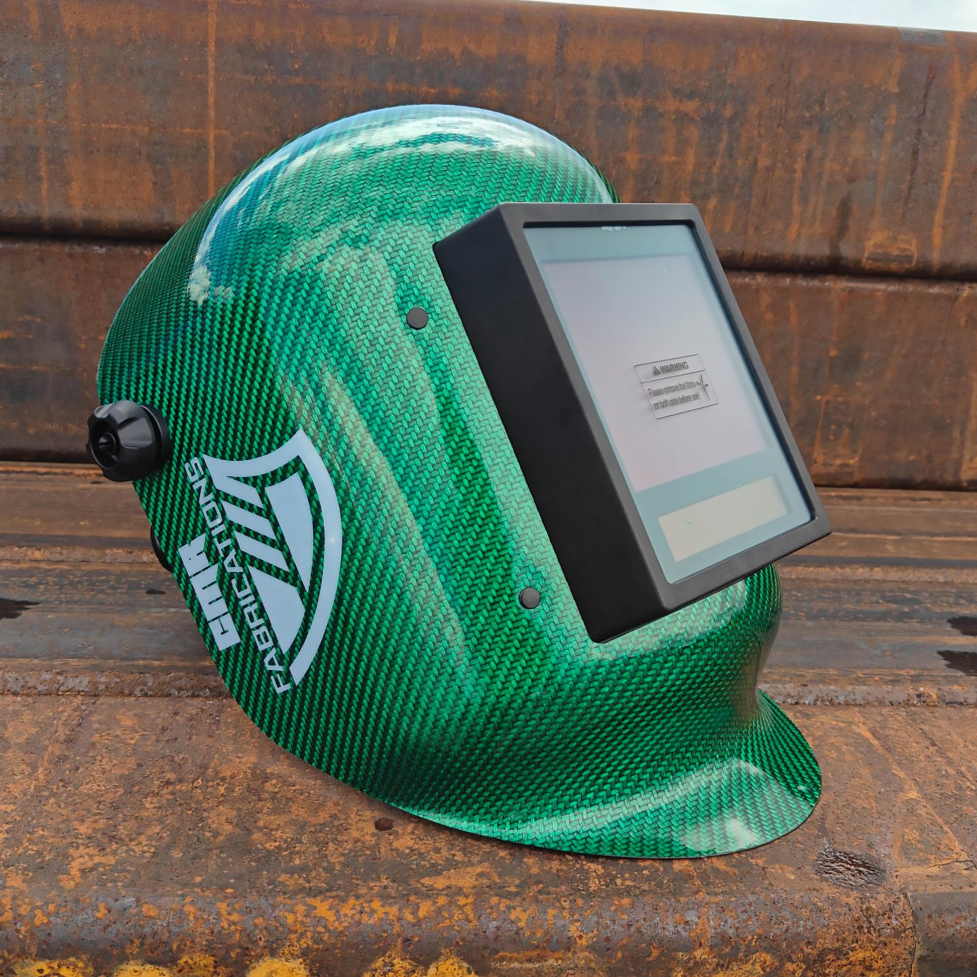 CMR Fabrications Carbon fiber Pipeliners Sugar scoop welding helmet Blue with digital display on a rusty metal surface