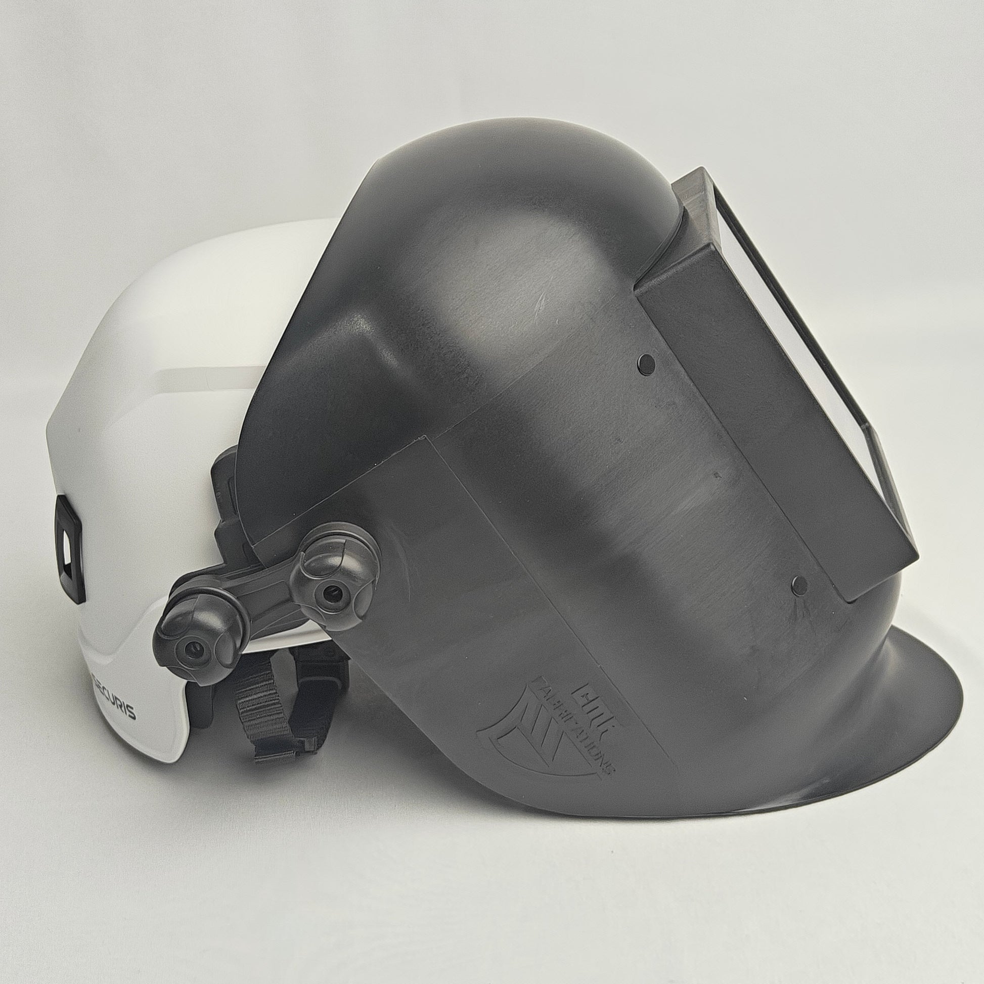 White hard hat with a gray welding helmet on a light gray background