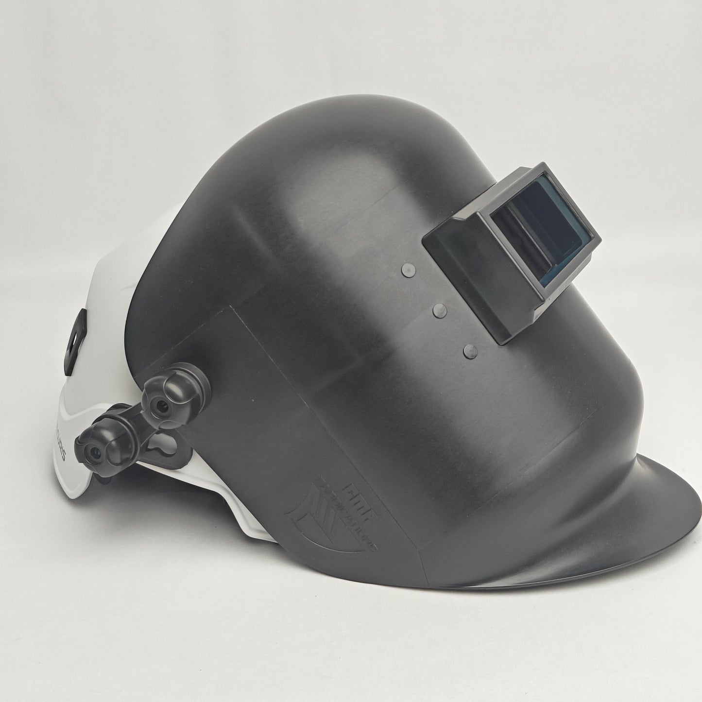 Black welding helmet with a white side panel on a light gray background
